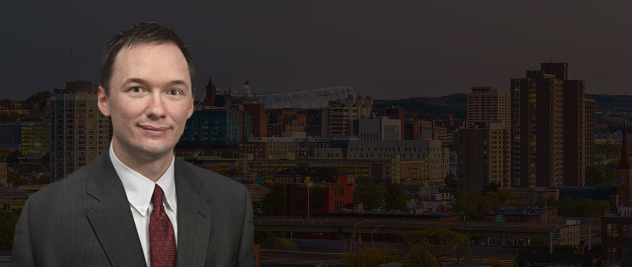 Attorney Steven R. Dolson with the Syracuse skyline in the background